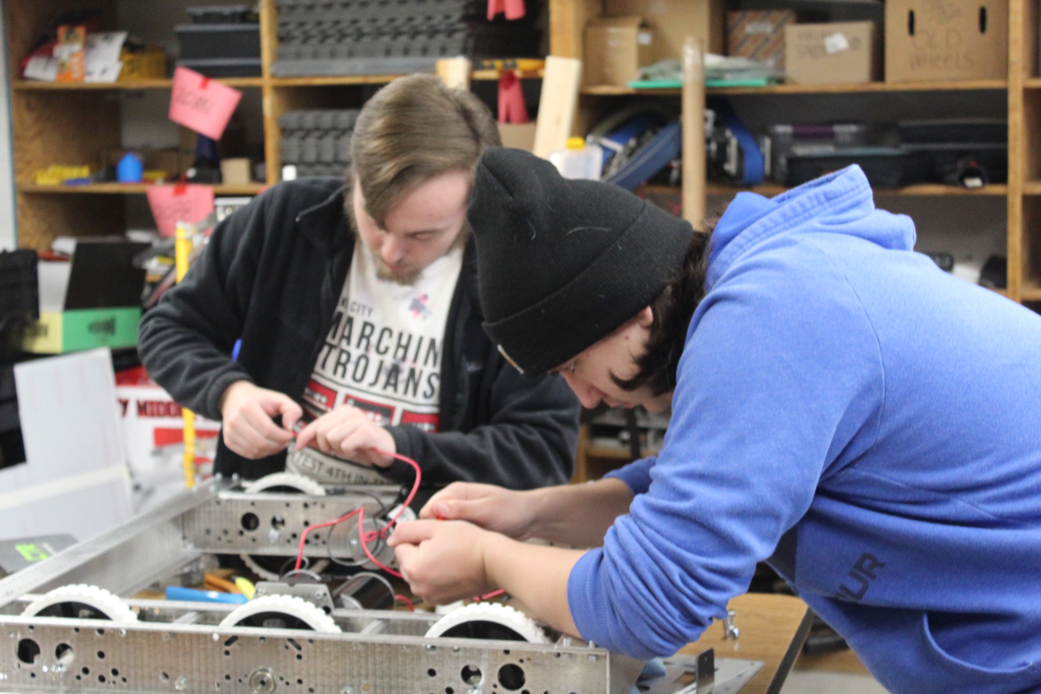 Student working on robot electrical systems